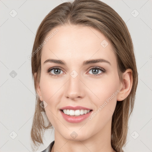 Joyful white young-adult female with medium  brown hair and grey eyes