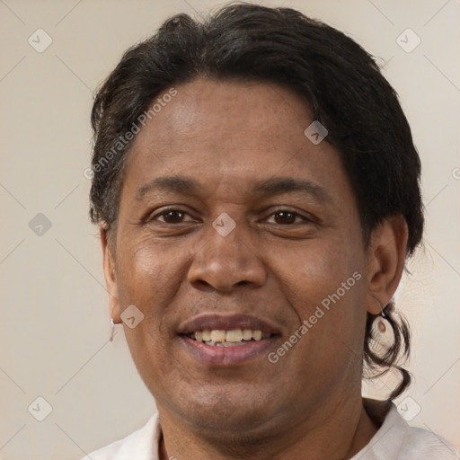 Joyful latino adult male with short  brown hair and brown eyes