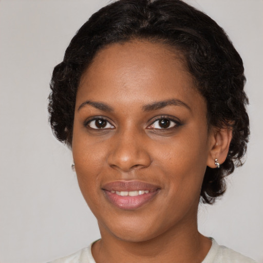 Joyful black young-adult female with short  brown hair and brown eyes