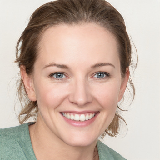 Joyful white young-adult female with medium  brown hair and blue eyes