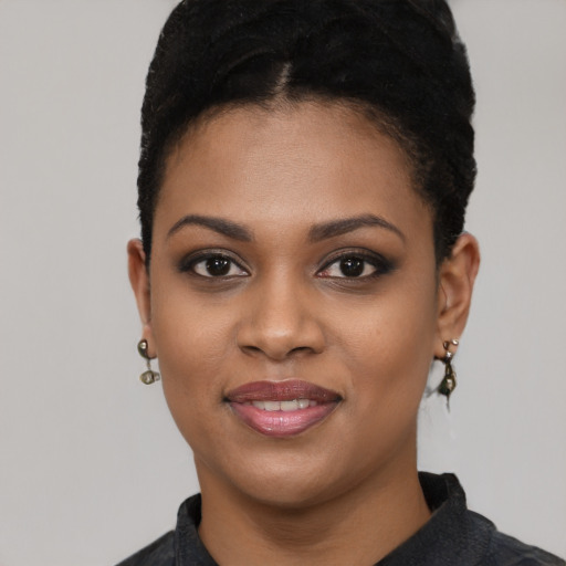 Joyful black young-adult female with short  black hair and brown eyes