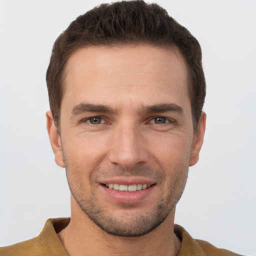 Joyful white young-adult male with short  brown hair and brown eyes