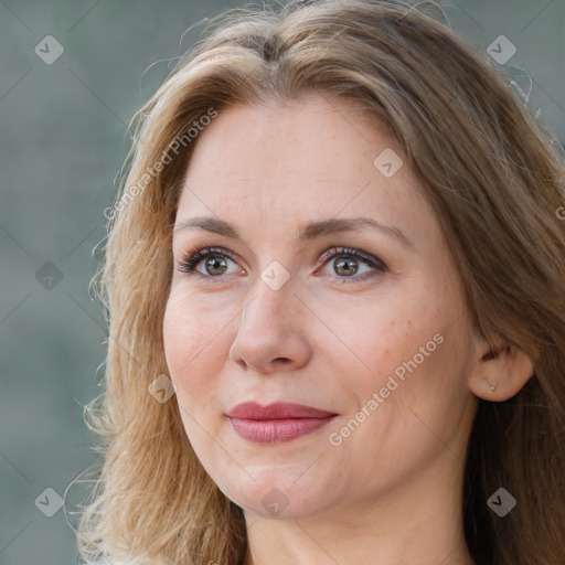 Joyful white adult female with long  brown hair and brown eyes