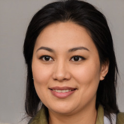 Joyful latino young-adult female with medium  brown hair and brown eyes