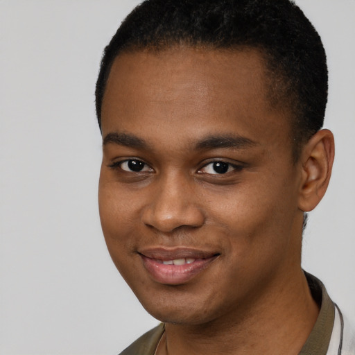 Joyful black young-adult male with short  brown hair and brown eyes