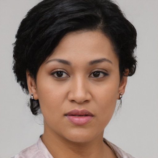 Joyful latino young-adult female with medium  black hair and brown eyes