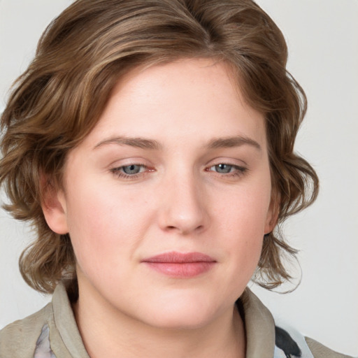 Joyful white young-adult female with medium  brown hair and blue eyes