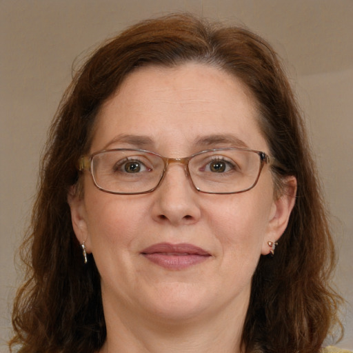 Joyful white adult female with long  brown hair and brown eyes