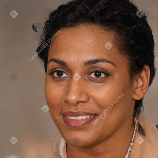 Joyful black young-adult female with short  brown hair and brown eyes