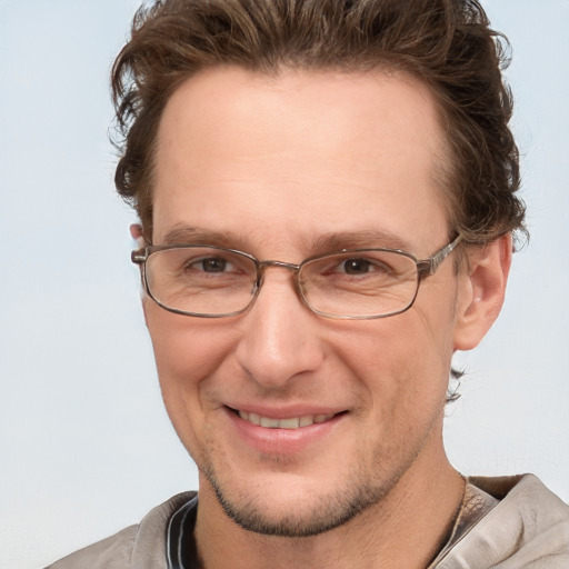 Joyful white adult male with short  brown hair and grey eyes