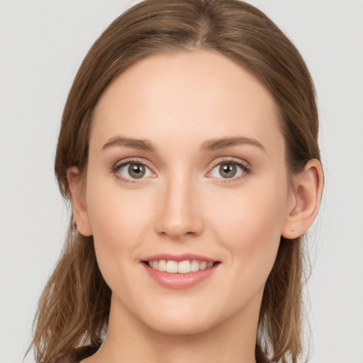 Joyful white young-adult female with long  brown hair and grey eyes