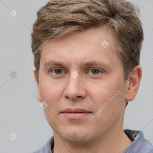 Joyful white adult male with short  brown hair and grey eyes