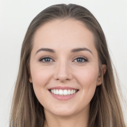 Joyful white young-adult female with long  brown hair and grey eyes