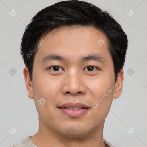 Joyful asian young-adult male with short  brown hair and brown eyes