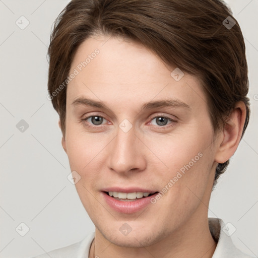 Joyful white young-adult female with short  brown hair and grey eyes