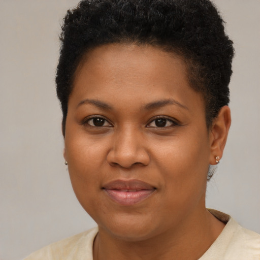 Joyful black young-adult female with short  brown hair and brown eyes