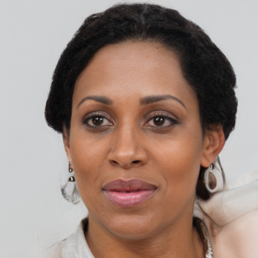 Joyful black adult female with short  brown hair and brown eyes