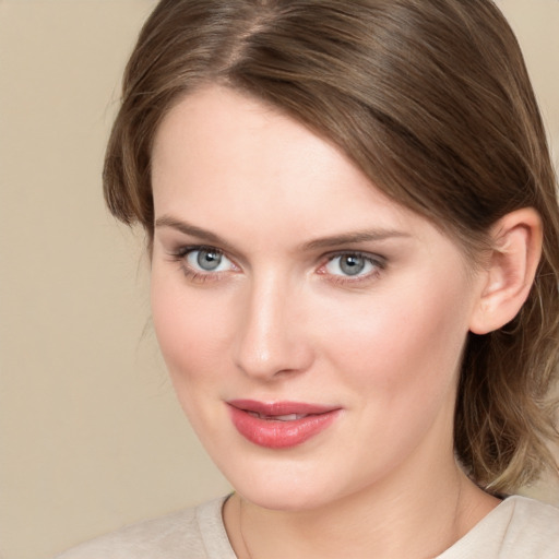 Joyful white young-adult female with medium  brown hair and grey eyes