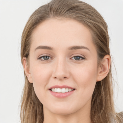 Joyful white young-adult female with long  brown hair and grey eyes