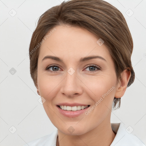 Joyful white young-adult female with medium  brown hair and grey eyes