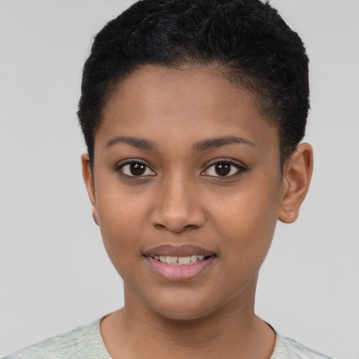 Joyful black young-adult female with short  brown hair and brown eyes