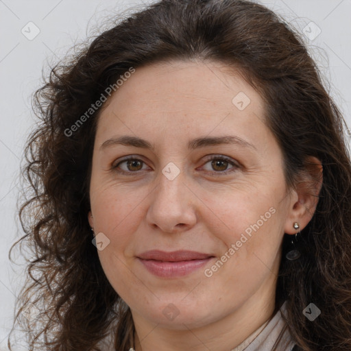 Joyful white adult female with long  brown hair and brown eyes