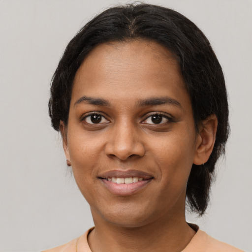 Joyful black young-adult female with medium  black hair and brown eyes