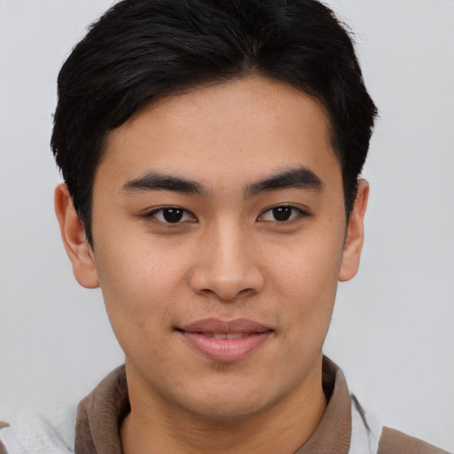 Joyful asian young-adult male with short  brown hair and brown eyes