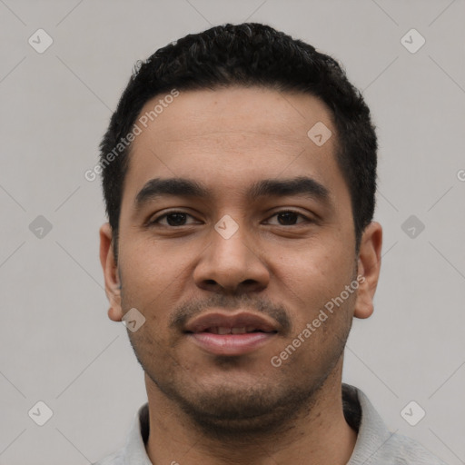Joyful latino young-adult male with short  black hair and brown eyes