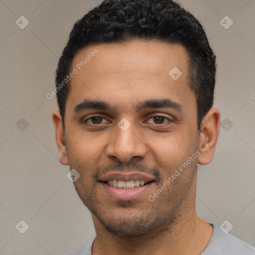 Joyful latino young-adult male with short  black hair and brown eyes