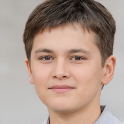 Joyful white child male with short  brown hair and brown eyes