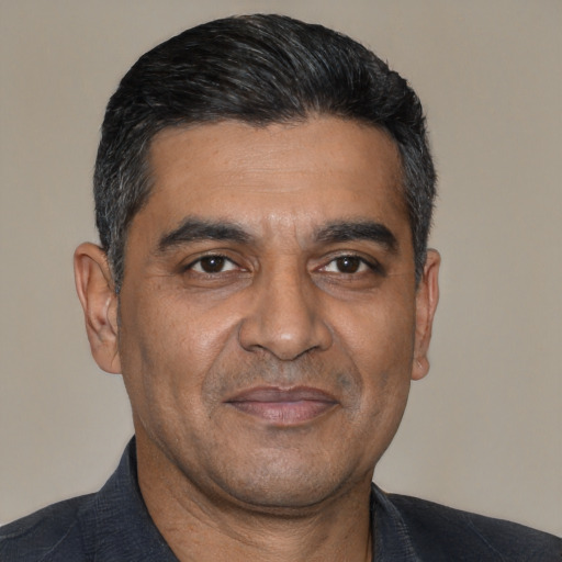 Joyful latino adult male with short  black hair and brown eyes
