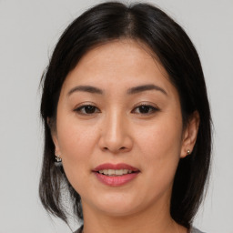 Joyful asian young-adult female with medium  brown hair and brown eyes