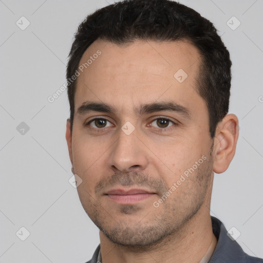 Joyful white young-adult male with short  black hair and brown eyes