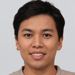 Joyful asian young-adult male with short  black hair and brown eyes