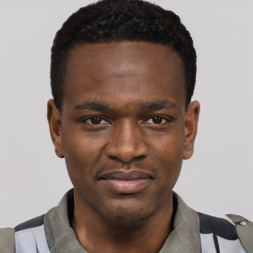 Joyful black young-adult male with short  black hair and brown eyes
