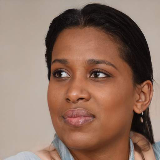 Joyful black young-adult female with medium  black hair and brown eyes