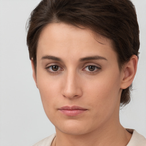 Neutral white young-adult female with short  brown hair and brown eyes