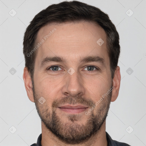 Joyful white adult male with short  brown hair and brown eyes