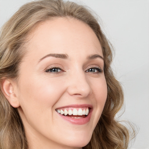 Joyful white young-adult female with long  brown hair and green eyes