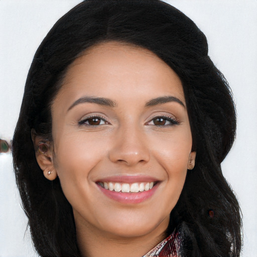 Joyful latino young-adult female with long  brown hair and brown eyes