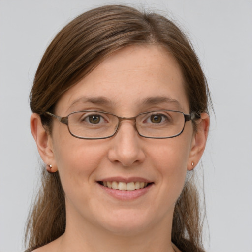 Joyful white adult female with medium  brown hair and grey eyes