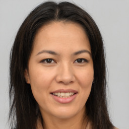 Joyful white young-adult female with long  brown hair and brown eyes