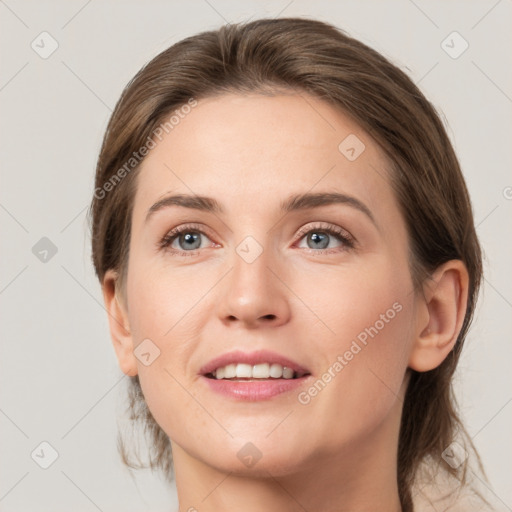 Joyful white young-adult female with medium  brown hair and grey eyes