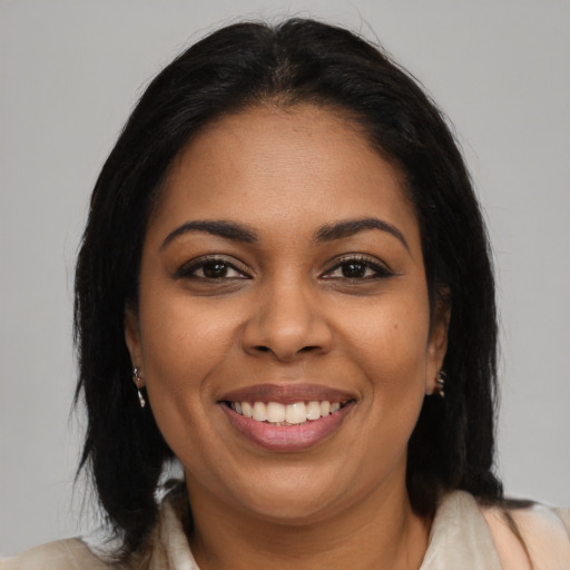 Joyful latino young-adult female with medium  brown hair and brown eyes