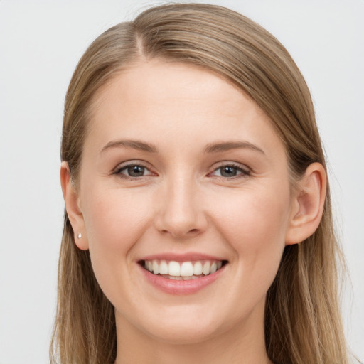 Joyful white young-adult female with long  brown hair and grey eyes