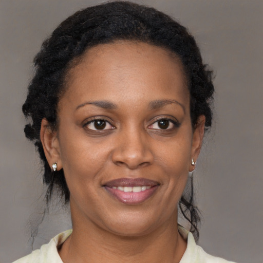 Joyful black young-adult female with medium  brown hair and brown eyes