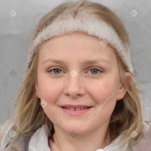 Joyful white young-adult female with medium  brown hair and blue eyes