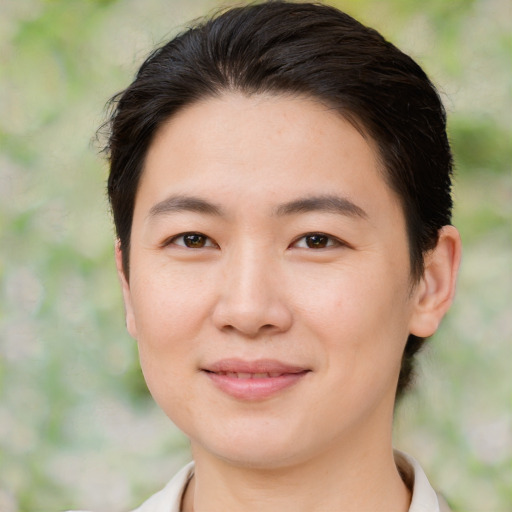 Joyful asian young-adult female with short  brown hair and brown eyes
