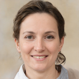 Joyful white adult female with medium  brown hair and brown eyes